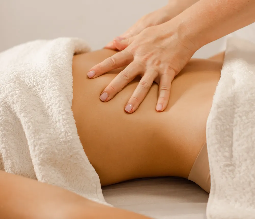 Patient with hands on their belly
